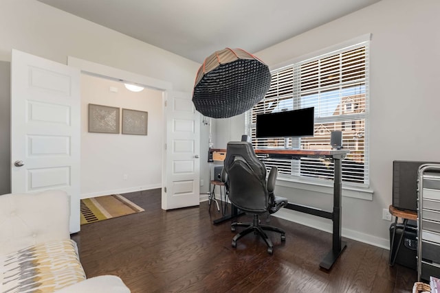 home office with dark hardwood / wood-style flooring