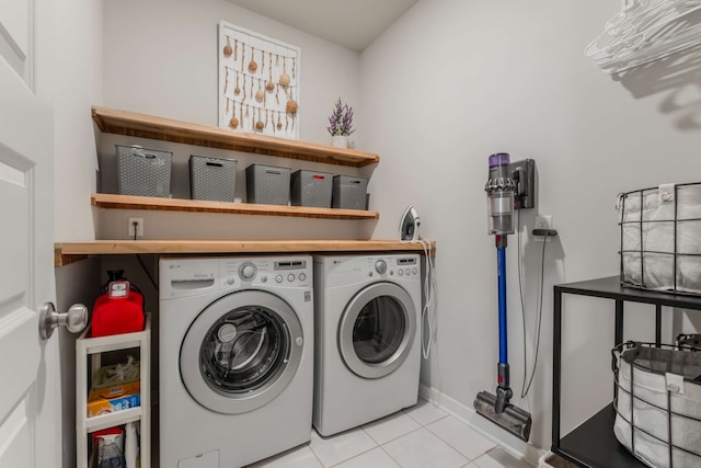 laundry room featuring independent washer and dryer and light tile patterned floors