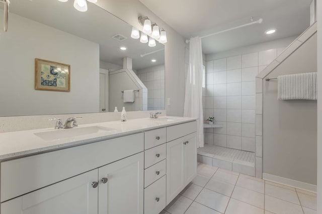 bathroom with tile patterned flooring, a shower with shower curtain, and vanity