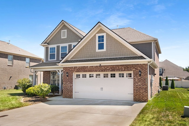 craftsman inspired home featuring cooling unit, a garage, and a front lawn