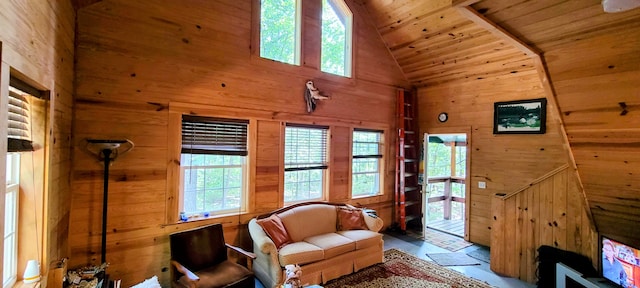 living room featuring wood walls, high vaulted ceiling, and wooden ceiling