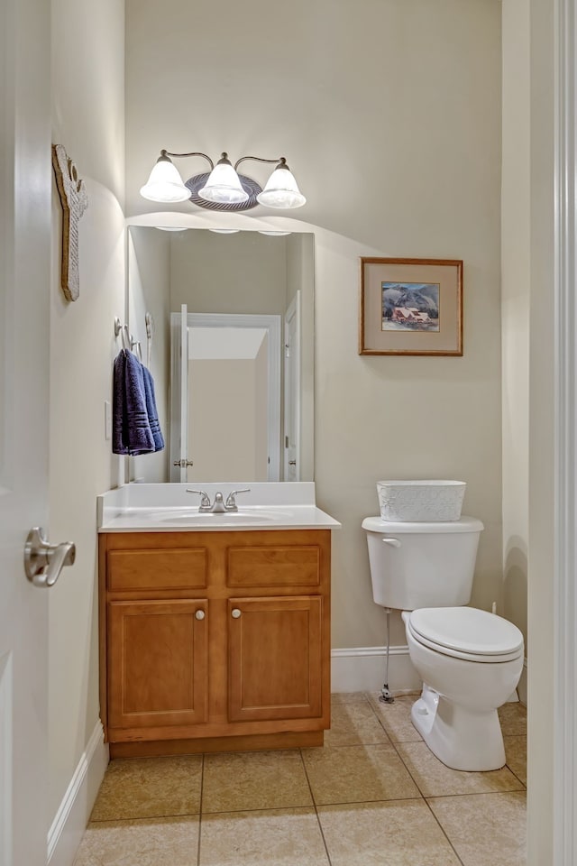 bathroom featuring tile patterned flooring, vanity, and toilet