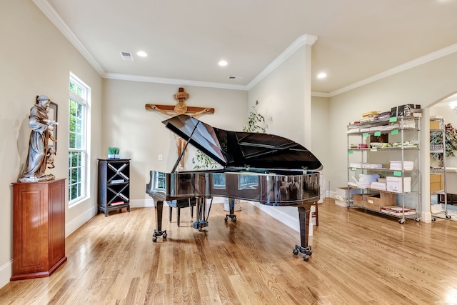 misc room with ceiling fan, light hardwood / wood-style flooring, and ornamental molding