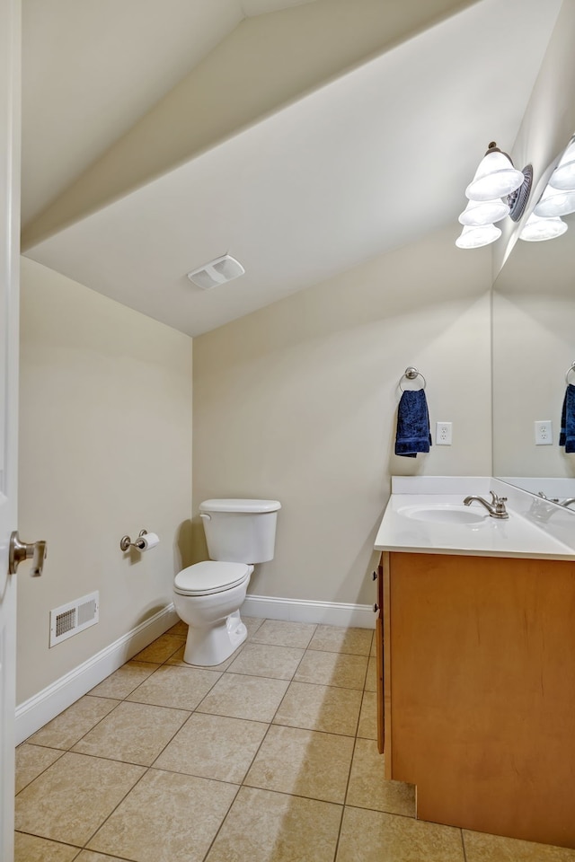 bathroom featuring tile patterned floors, vanity, lofted ceiling, and toilet