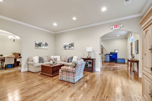 living room featuring a notable chandelier, light hardwood / wood-style floors, and ornamental molding