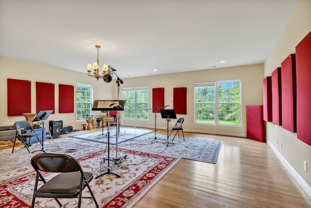 living room featuring a notable chandelier and light hardwood / wood-style flooring