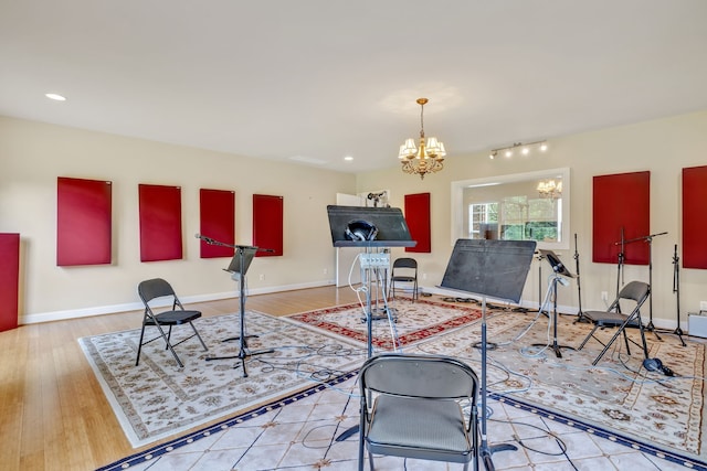 interior space with a notable chandelier, light hardwood / wood-style flooring, and track lighting