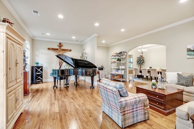 living room featuring an inviting chandelier, light hardwood / wood-style flooring, and ornamental molding