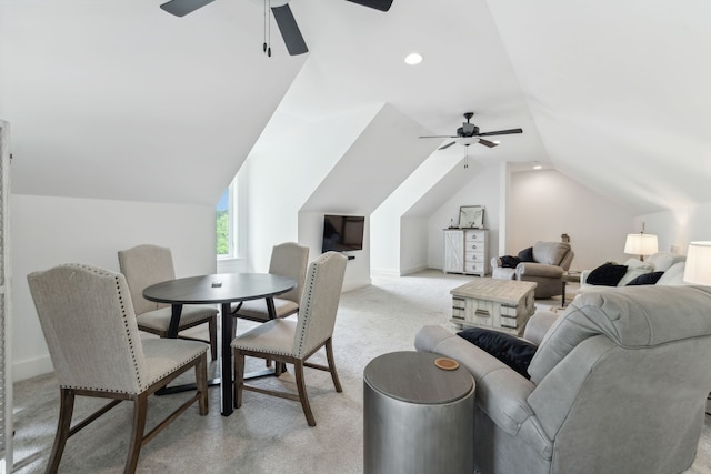 interior space featuring ceiling fan, light colored carpet, and lofted ceiling