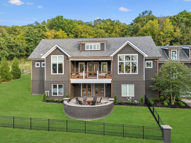 back of property featuring a patio area, a yard, an outdoor fire pit, and a balcony