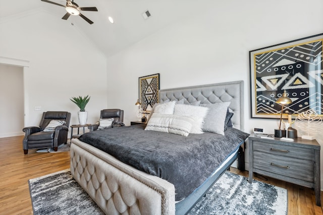 bedroom with high vaulted ceiling, ceiling fan, and hardwood / wood-style floors