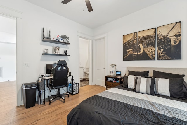 bedroom with light hardwood / wood-style flooring, ceiling fan, and connected bathroom