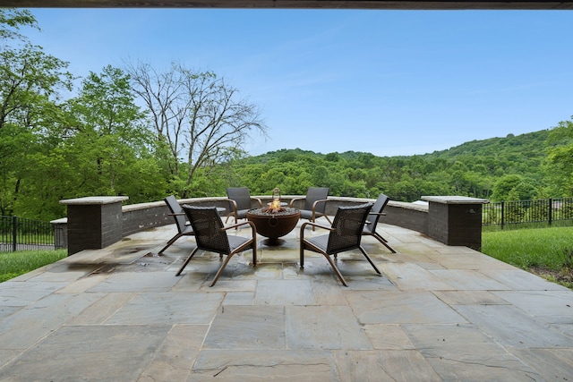 view of patio / terrace featuring an outdoor fire pit