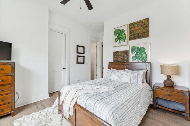 bedroom with ceiling fan and light hardwood / wood-style floors