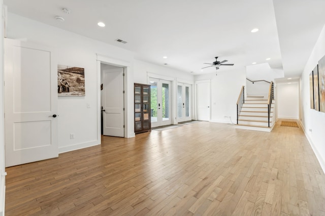 unfurnished living room featuring light hardwood / wood-style floors, french doors, and ceiling fan