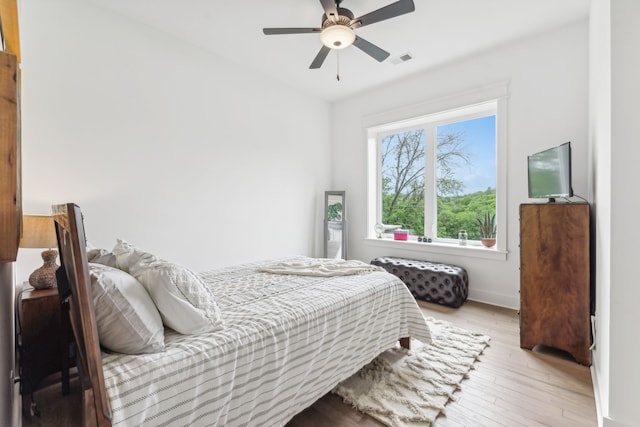 bedroom with ceiling fan and light hardwood / wood-style floors