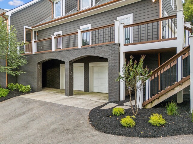 exterior space with a balcony and a garage