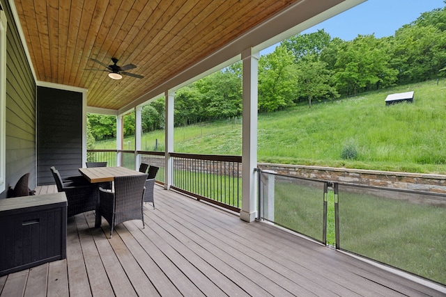 deck featuring a lawn and ceiling fan