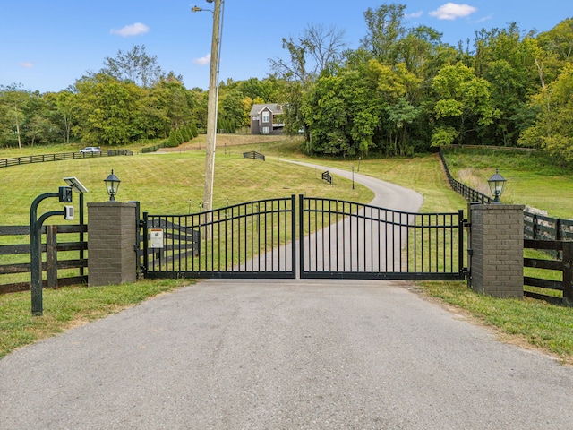 view of gate featuring a yard