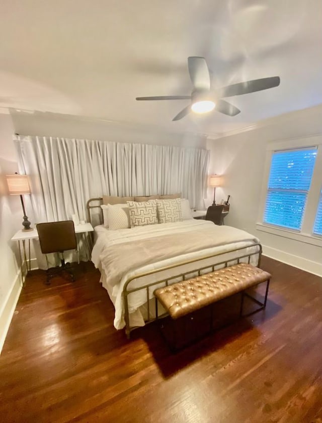 bedroom featuring ceiling fan, baseboards, and wood finished floors