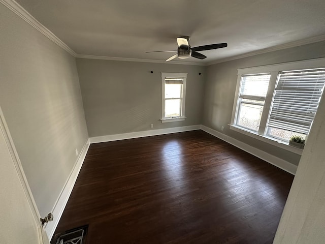 unfurnished room featuring dark wood-type flooring, a ceiling fan, baseboards, and ornamental molding