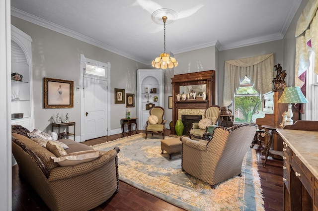 living room with ornamental molding, a fireplace, wood finished floors, and baseboards