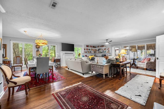 living room featuring plenty of natural light, visible vents, and wood finished floors