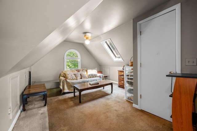 interior space featuring vaulted ceiling with skylight and carpet flooring