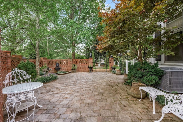 view of patio with fence and central air condition unit