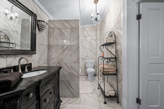 bathroom featuring toilet, a notable chandelier, tile walls, vanity, and marble finish floor