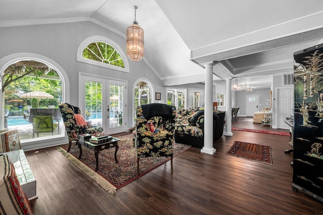 living room with wood finished floors, decorative columns, and a notable chandelier