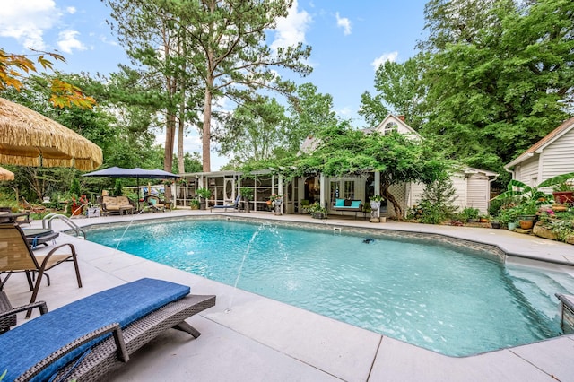 pool with a patio and an outdoor structure