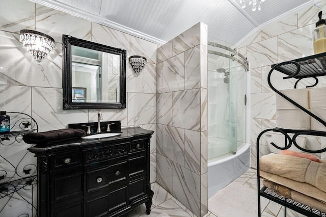 full bathroom with washtub / shower combination, marble finish floor, vanity, and tile walls