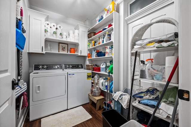 laundry area featuring dark wood-style floors, cabinet space, and washer and dryer