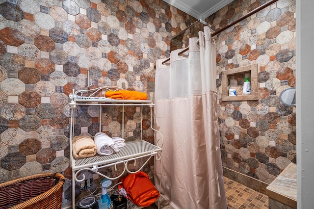 full bath with ornamental molding and tiled shower