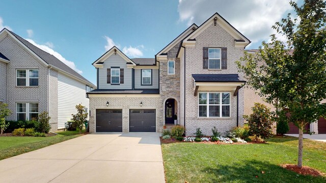 craftsman inspired home featuring a garage and a front yard