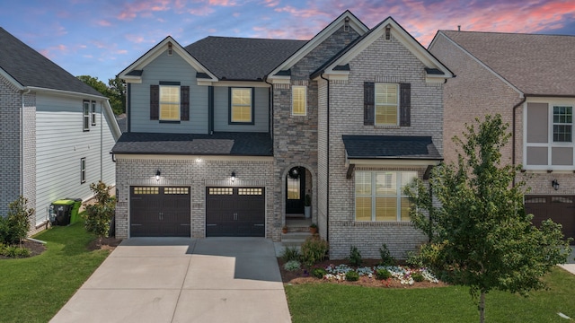 view of front of house featuring a garage and a yard