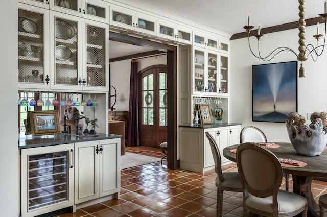 bar featuring a dry bar, beverage cooler, ornamental molding, and dark tile patterned flooring