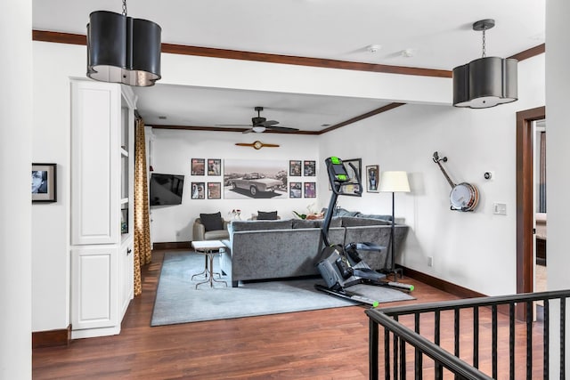 living room with dark wood-style floors, ceiling fan, baseboards, and ornamental molding