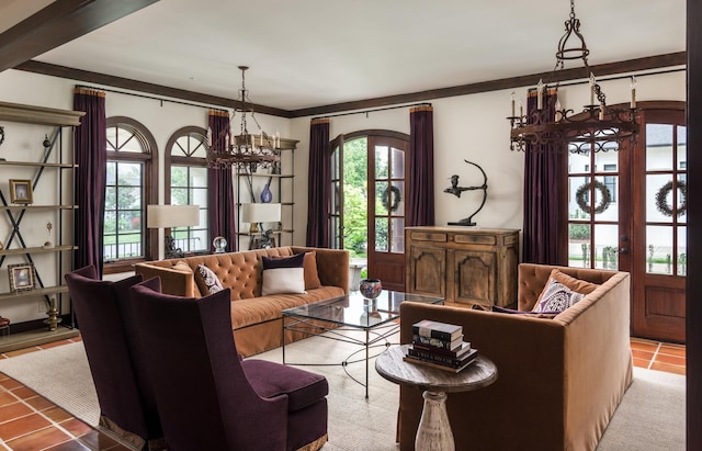 living room with ornamental molding, french doors, tile patterned flooring, and a chandelier