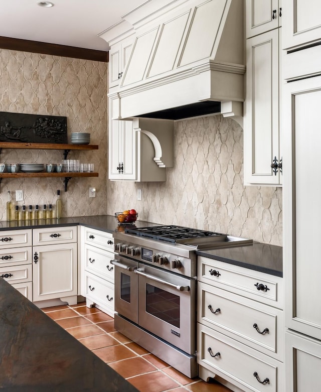 kitchen with premium range hood, dark countertops, and double oven range