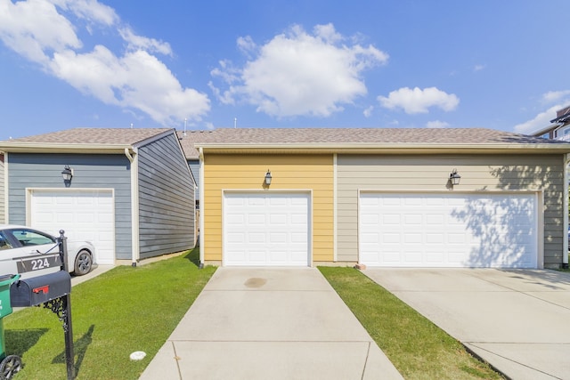 ranch-style house featuring a garage and a front yard