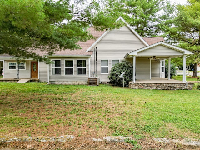 view of front of home with a patio area, a front lawn, and central air condition unit