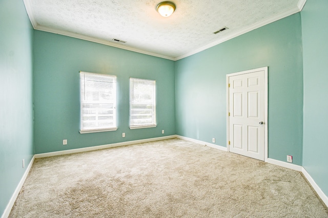 carpeted spare room with ornamental molding and a textured ceiling