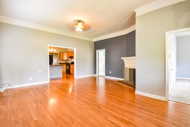 unfurnished living room featuring ornamental molding and hardwood / wood-style flooring