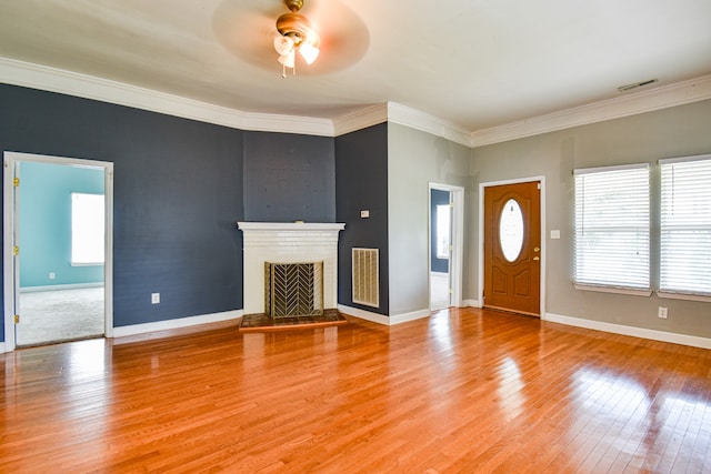 unfurnished living room with crown molding, ceiling fan, and hardwood / wood-style flooring