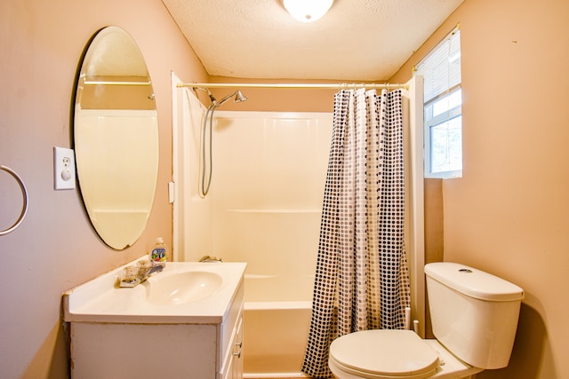 full bathroom featuring vanity, toilet, shower / bath combo with shower curtain, and a textured ceiling