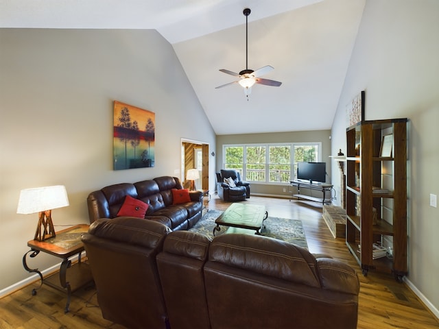 living room with ceiling fan, dark hardwood / wood-style floors, and high vaulted ceiling