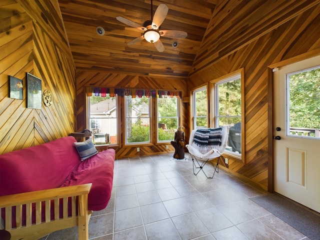 sunroom / solarium with ceiling fan, vaulted ceiling, wood ceiling, and a healthy amount of sunlight