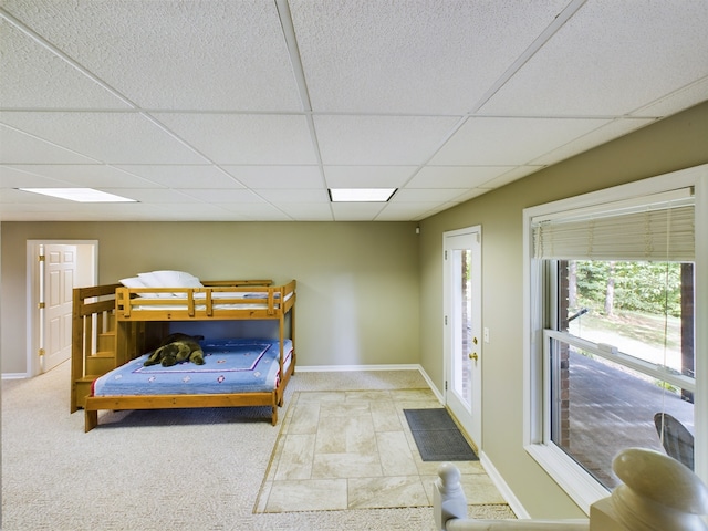 tiled bedroom with a paneled ceiling